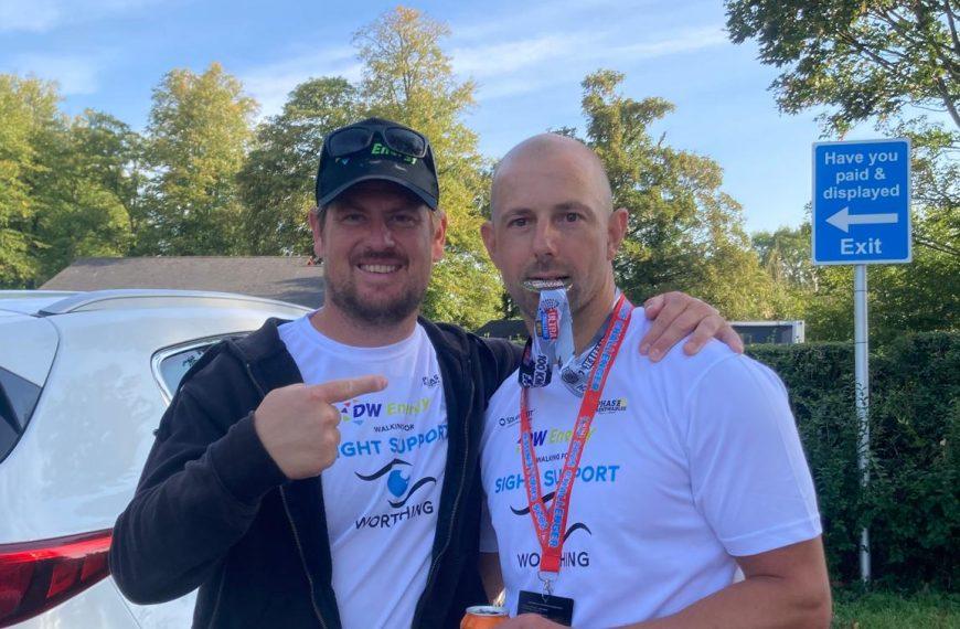 Simon and James from DW Energy wearing their SSW logo'd tshirts. One of them has a medal around their neck which they are biting.