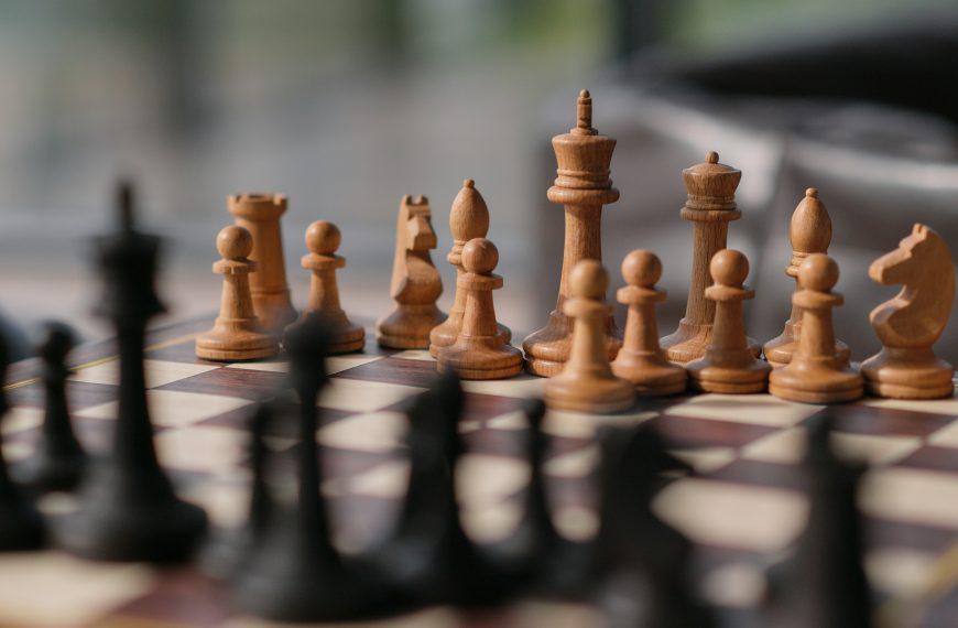 a photo of chess pieces on a chess board