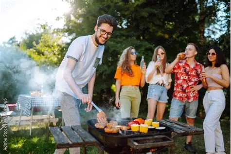 People stood around a barbeque