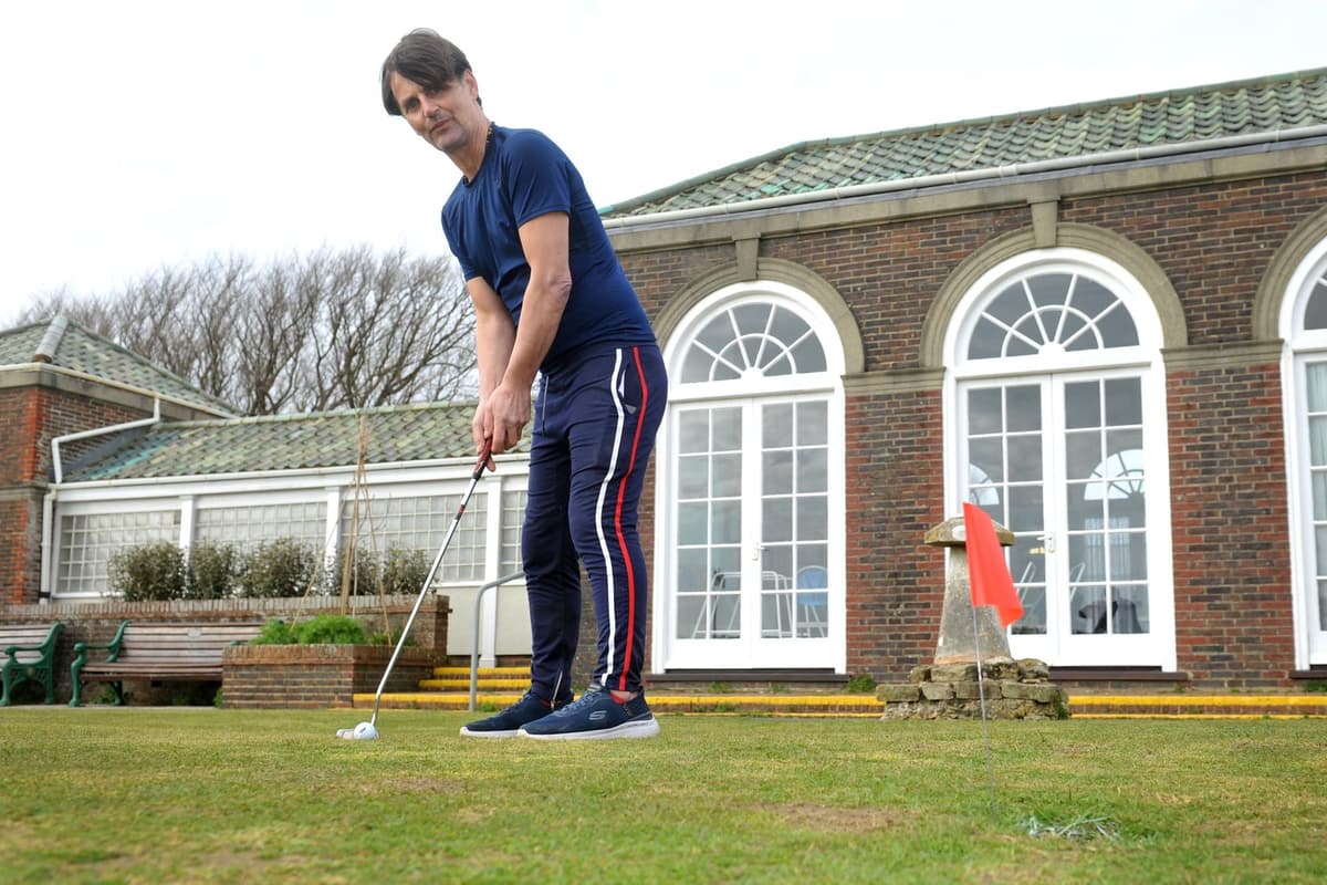 A man with a golf club