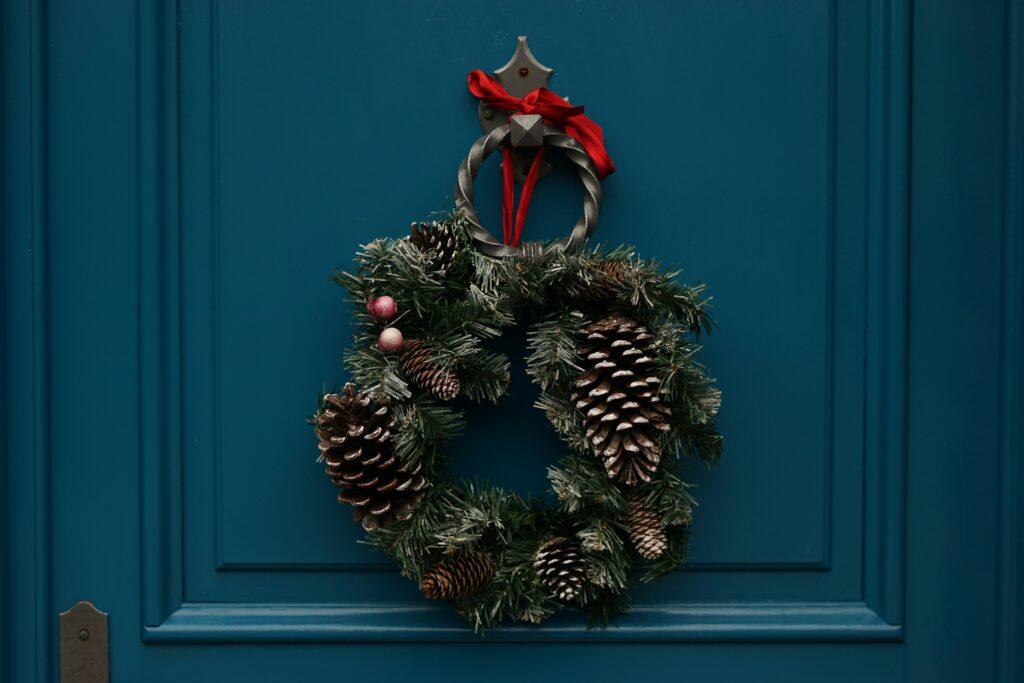 a Christmas wreath hanging on a front door
